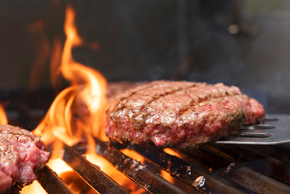 Hamburger patty on barbecue grill