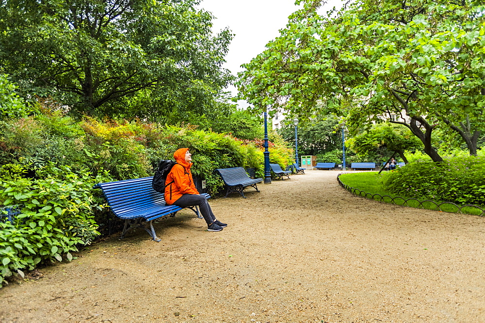 Mature woman wearing raincoat in park in Paris, France