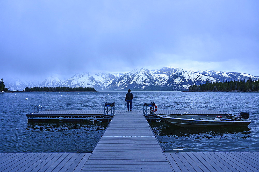 Woman standing on jetty on Jenny Lake in Grand Teton National Park, USA