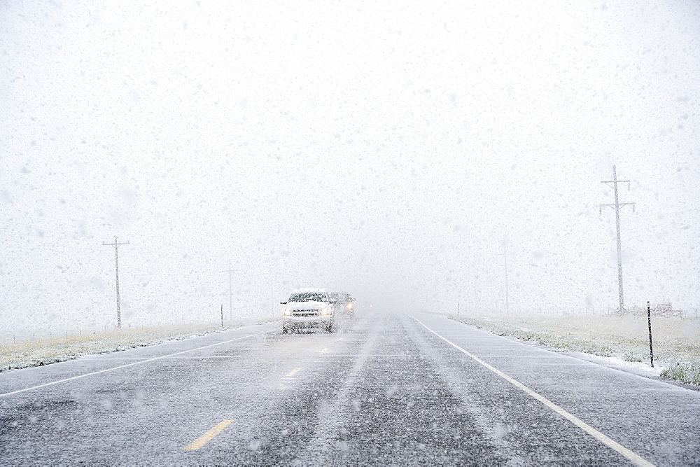 View through windscreen of car on highway during snow