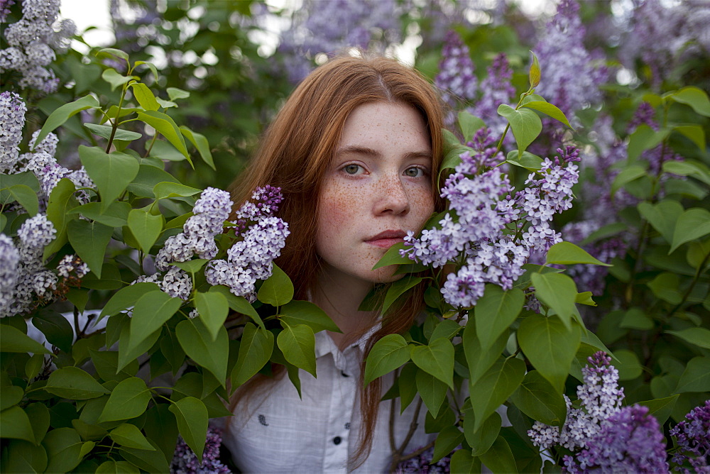 Teenage girl among purple flowers