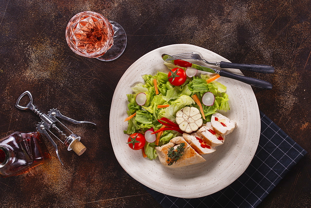 Lunch of chicken and salad with rose wine