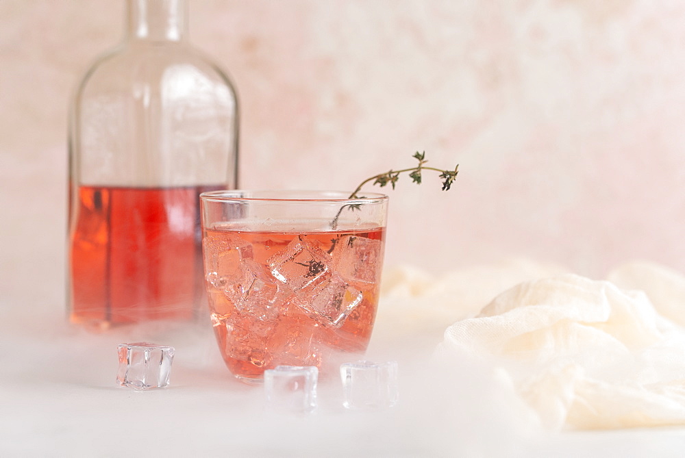 Pink cocktail with ice cubes