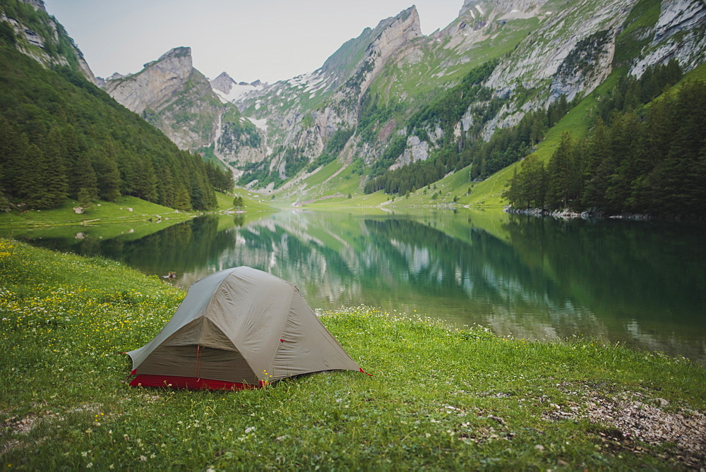 Tent by Seealpsee lake in Appenzell Alps, Switzerland