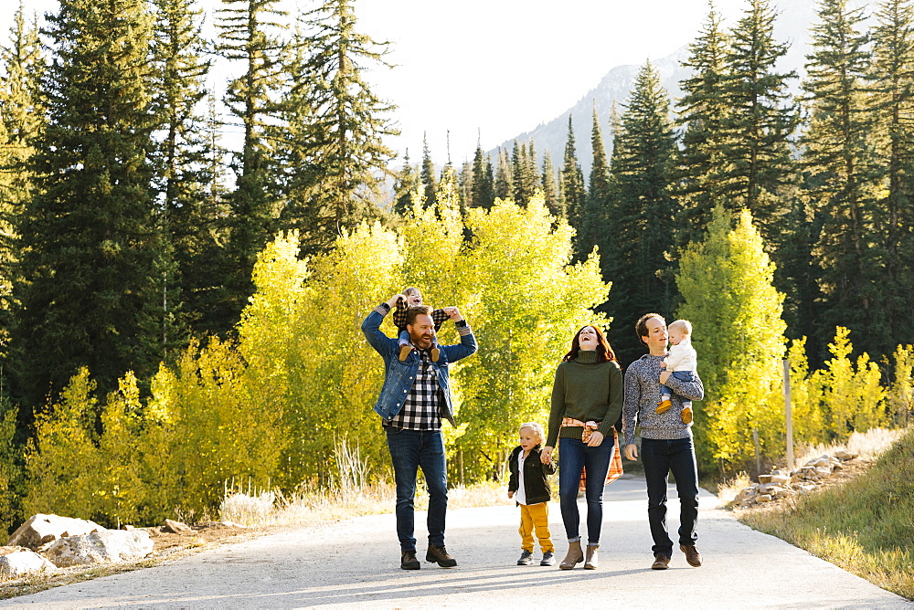 Family and friends on road through forest