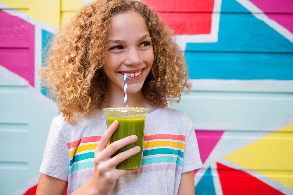 Girl drinking green juice