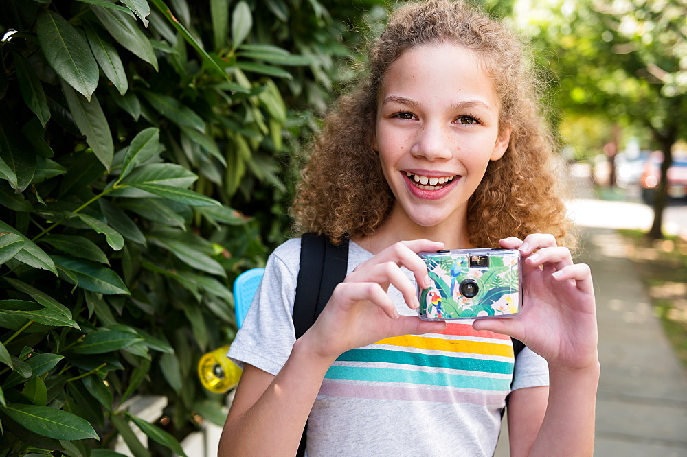 Girl holding film camera