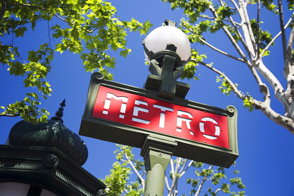 Low angle view of Metro sign on lamp post