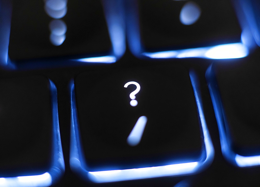 Illuminated question mark key on keyboard