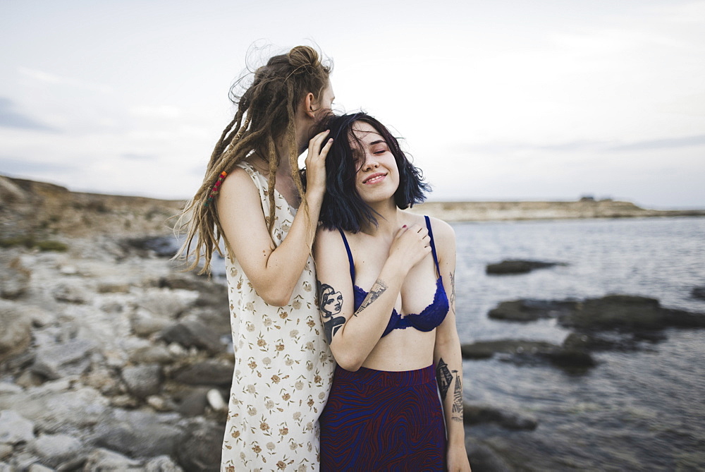 Young women standing together on beach