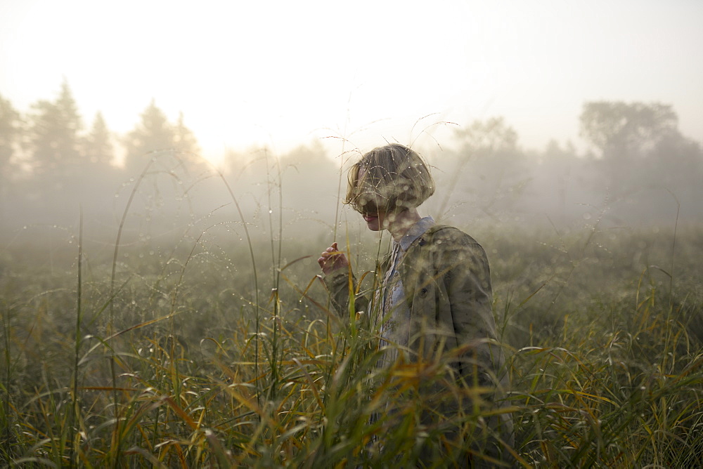 Young woman in field of long grass