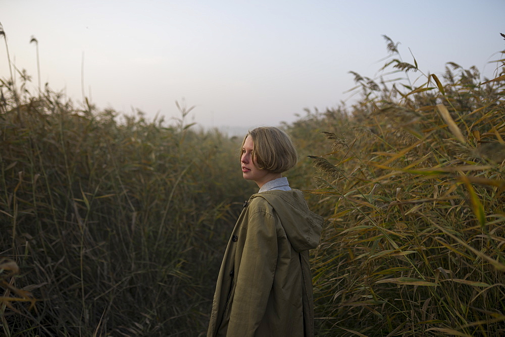 Young woman in field of long grass