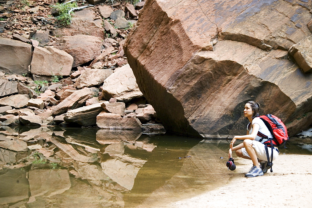 Female backpacker relaxing at a mountain lake