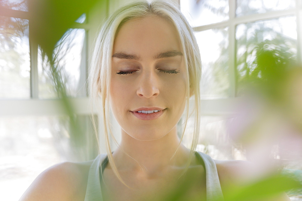 Portrait of young blonde woman with eyes closed