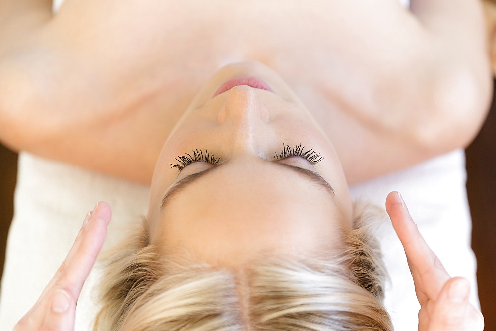 Woman getting head massage during spa treatment