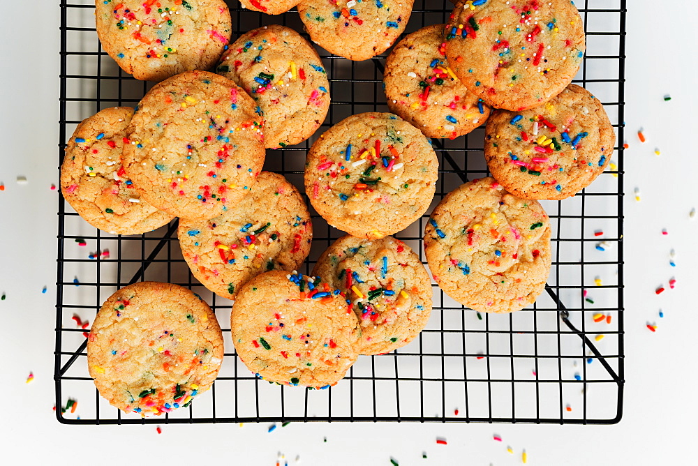 Homemade cookies with colorful sprinkle on baking rack 