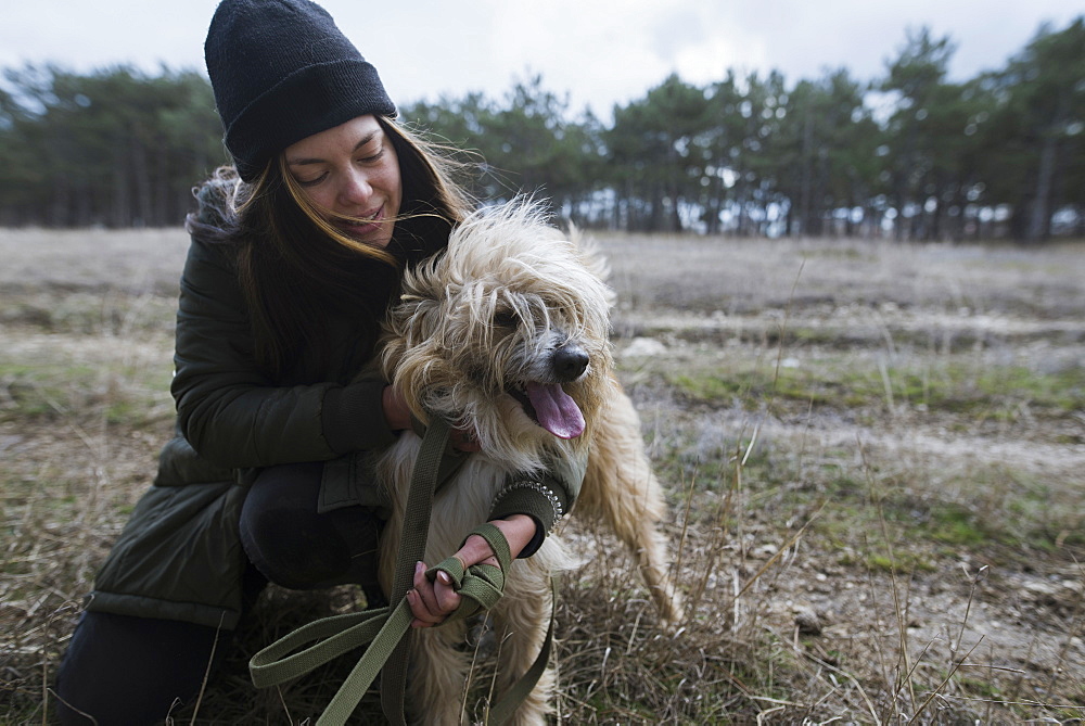 Young woman walking dog from animal shelter 