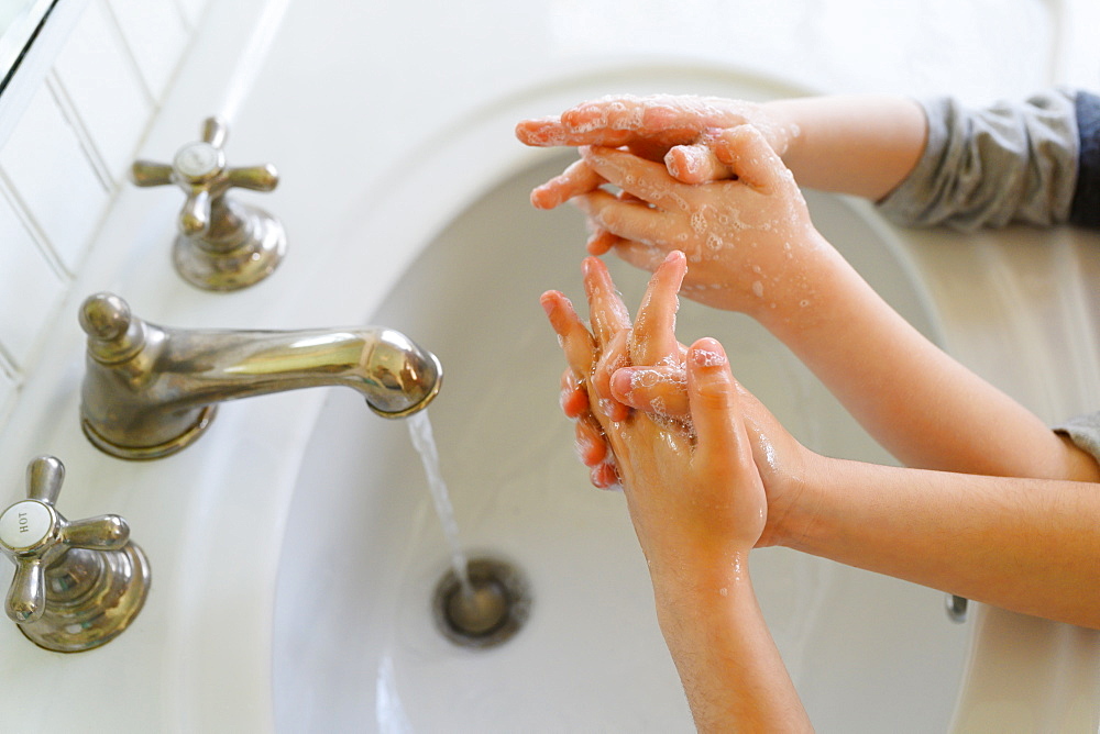 Close-up of children (4-5, 6-7) washing hands