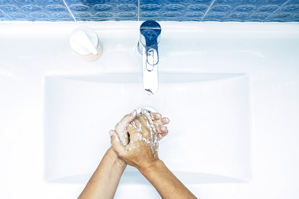 Close-up of teenage boy (16-17) washing hands 