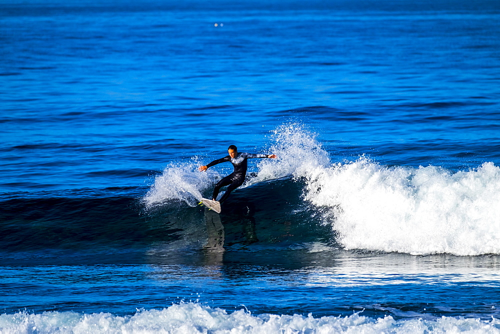 Teenage boy surfing waves