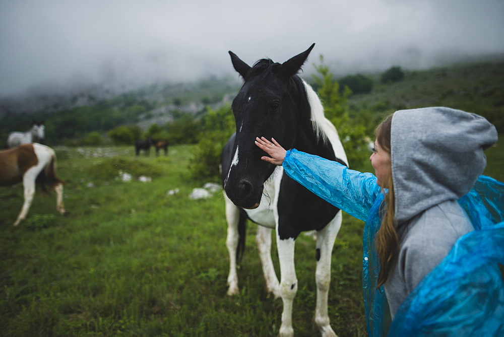 Woman petting Icelandic horse