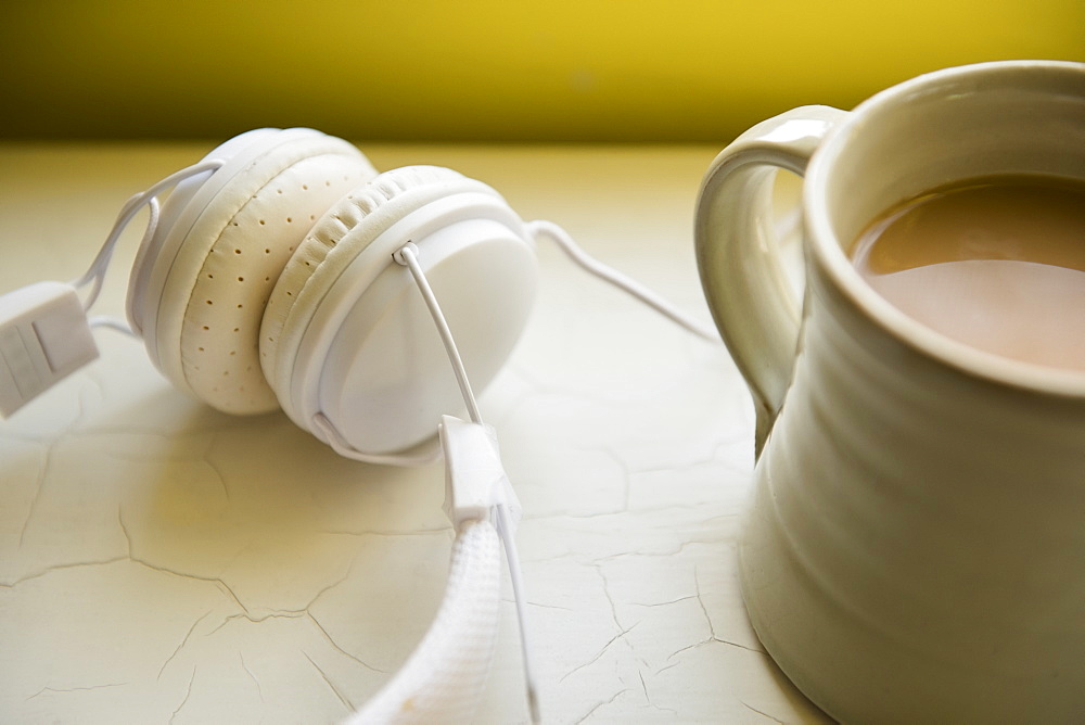 White headphones and cup of coffee