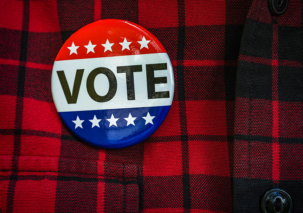 Vote button on red checked shirt