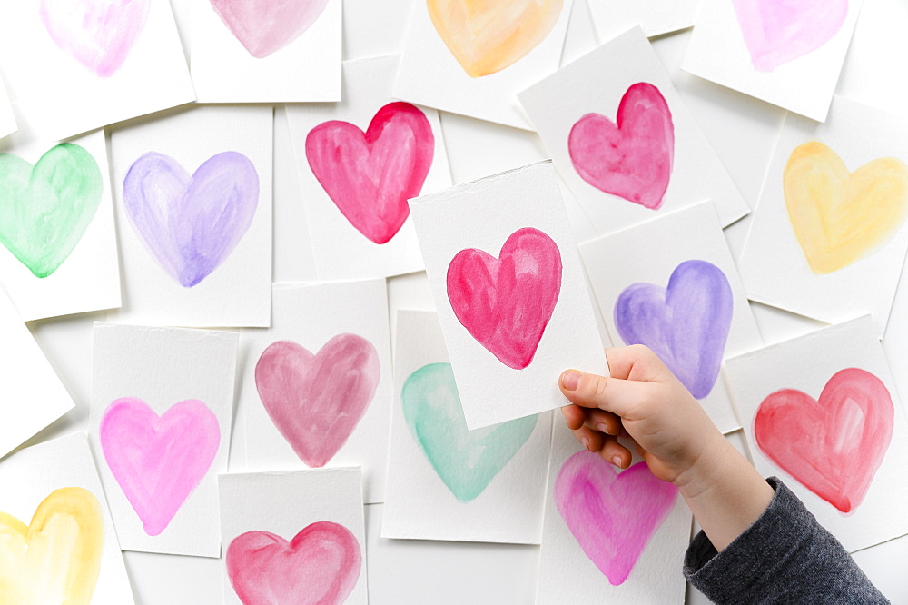 Child holding homemade Valentine card