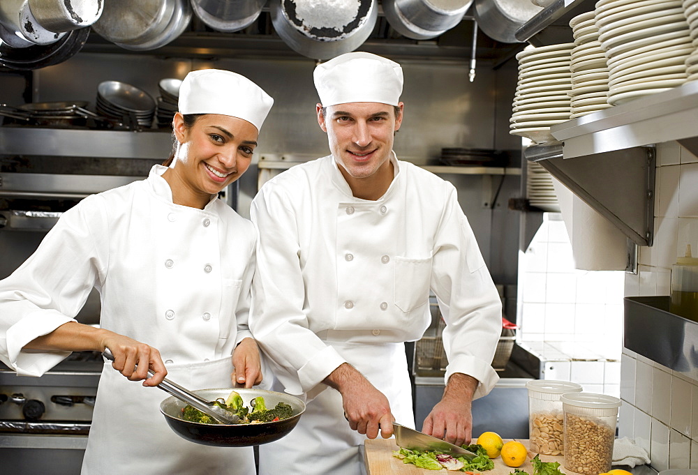 Male and female chefs in restaurant kitchen