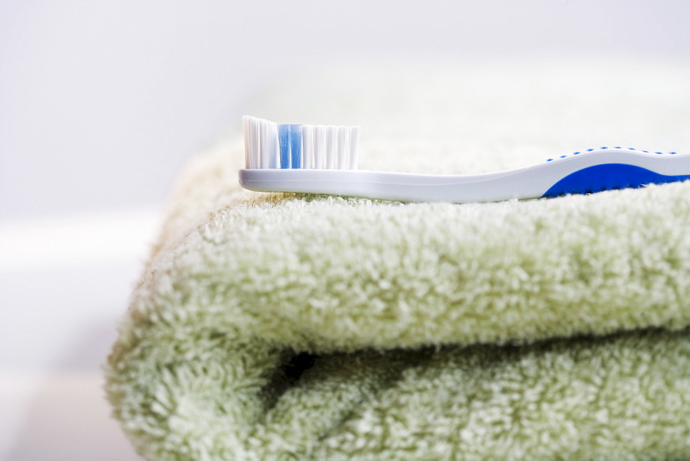 Close up of toothbrush on folded towel