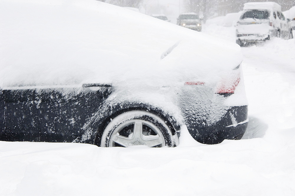 Car buried in snow in winter