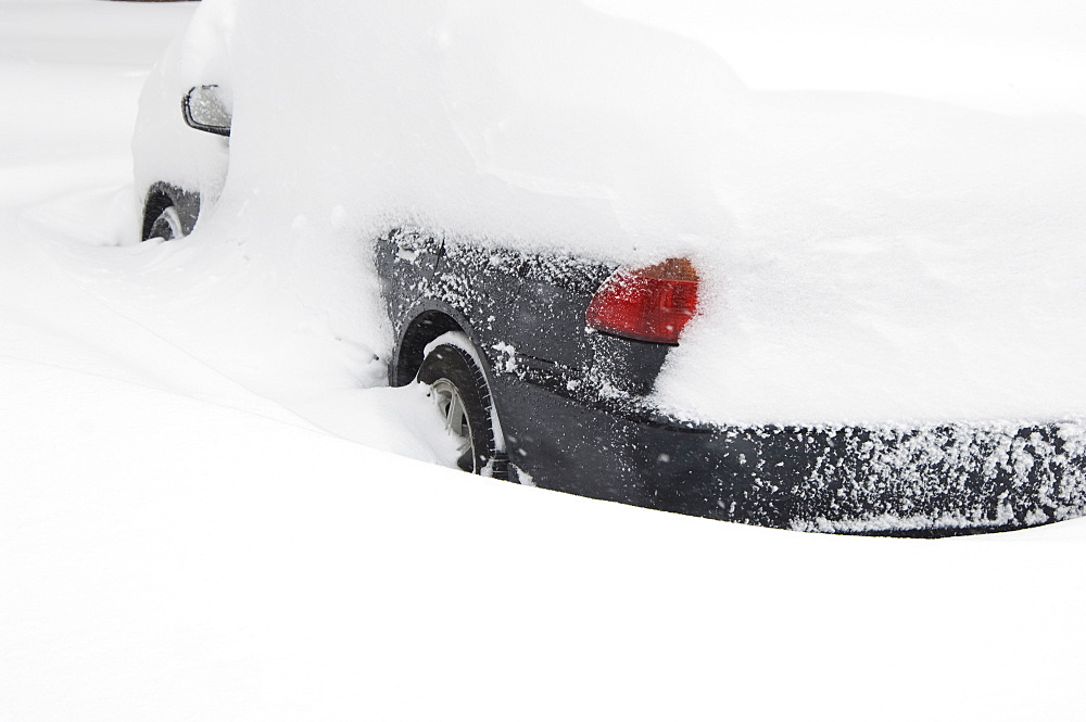 Car buried in snow in winter