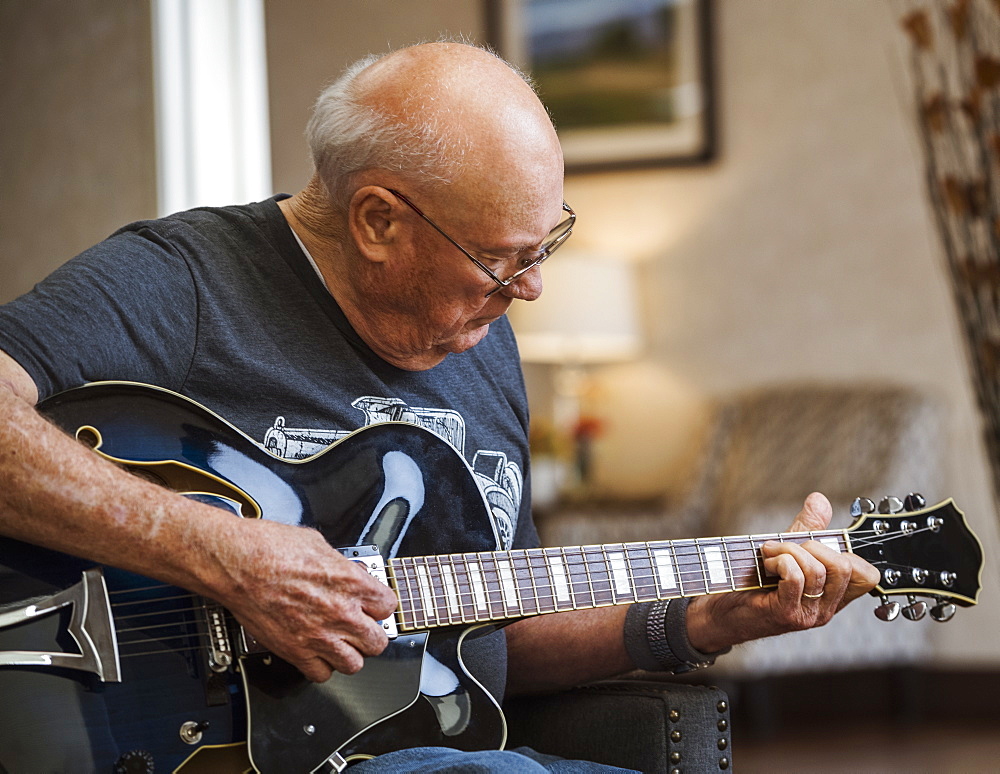 Senior man playing guitar