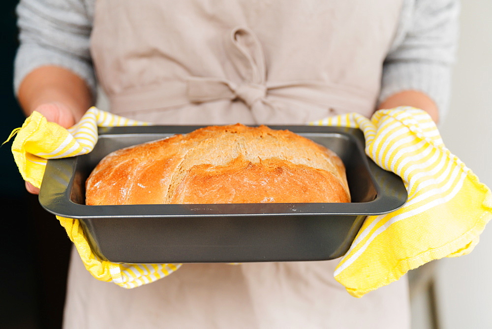 Woman holding freshly baked bread