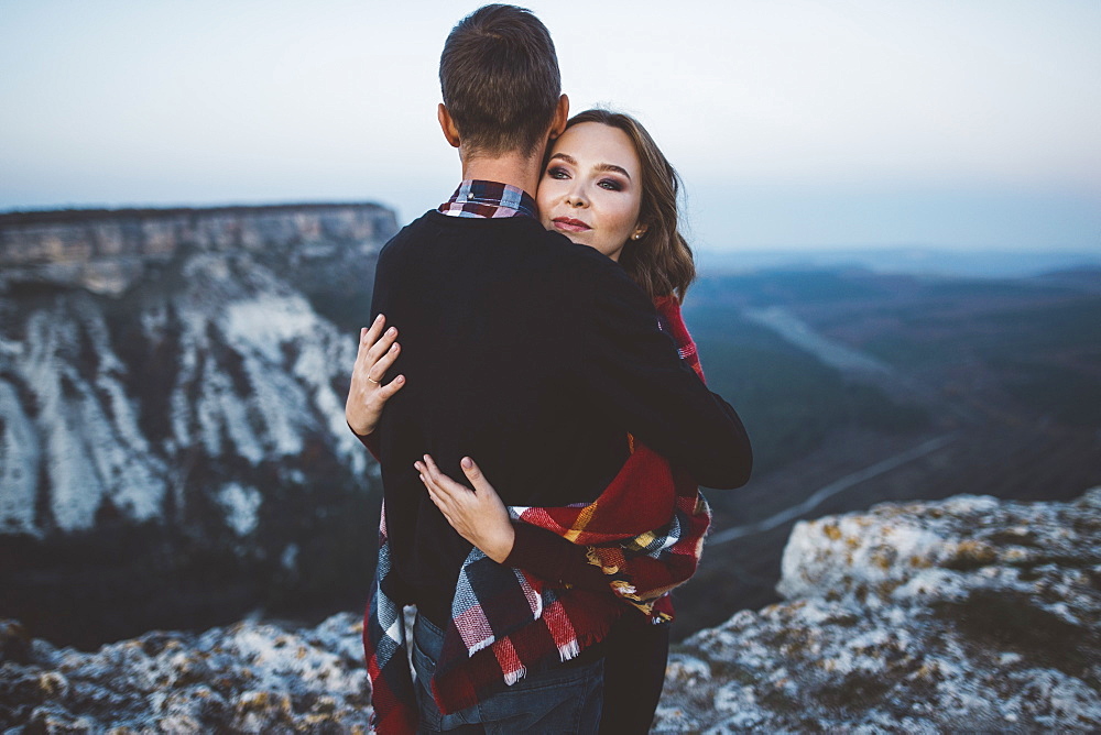 Ukraine, Crimea, Young couple hugging near canyon