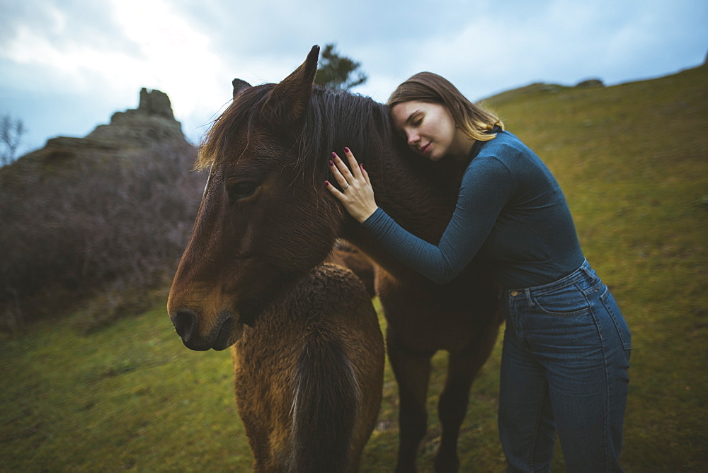 Ukraine, Crimea, Young woman embracing Icelandic horse