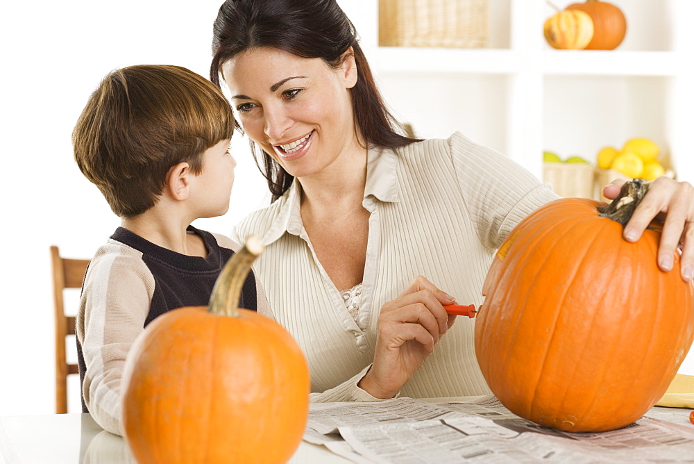 Mother and son carving pumpkins