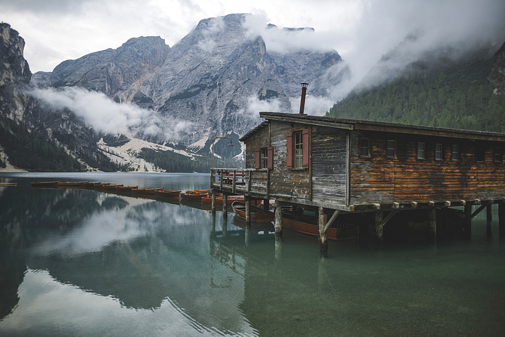 Italy, Wooden hut and boats at Pragser Wildsee in Dolomites