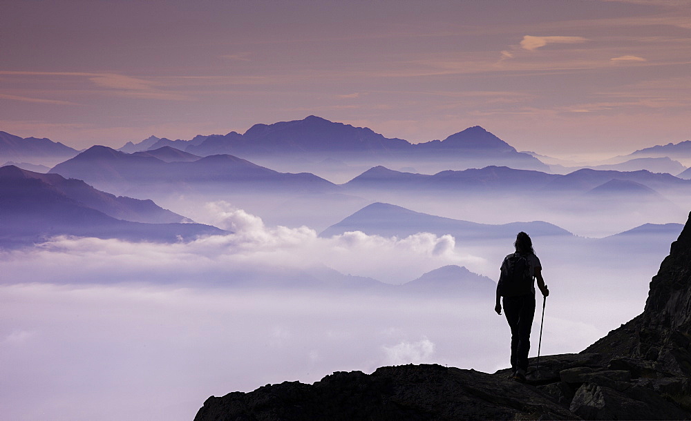 Italy, Piedmont, Alps, Monte Rosa, Silhouette of female climber on mountain ridge