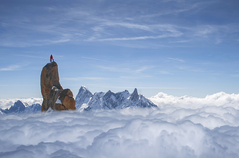 France, Chamonix, Mont Blanc, Aguille du midi, Climber standing on top of rock in mountains
