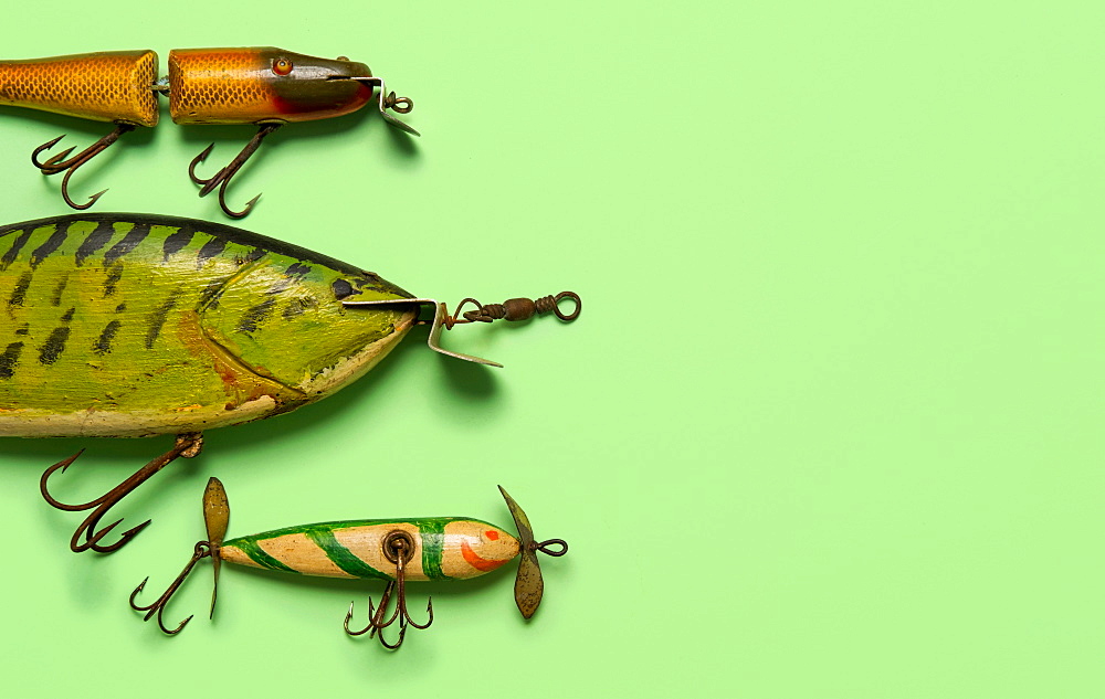 Antique fishing lures on green background