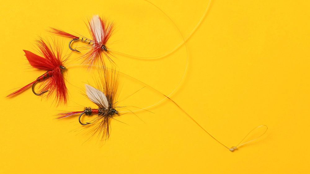 Antique fishing lures arranged on orange background