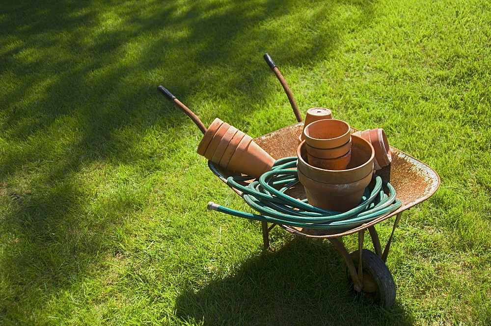 Still life of wheelbarrow and gardening tools