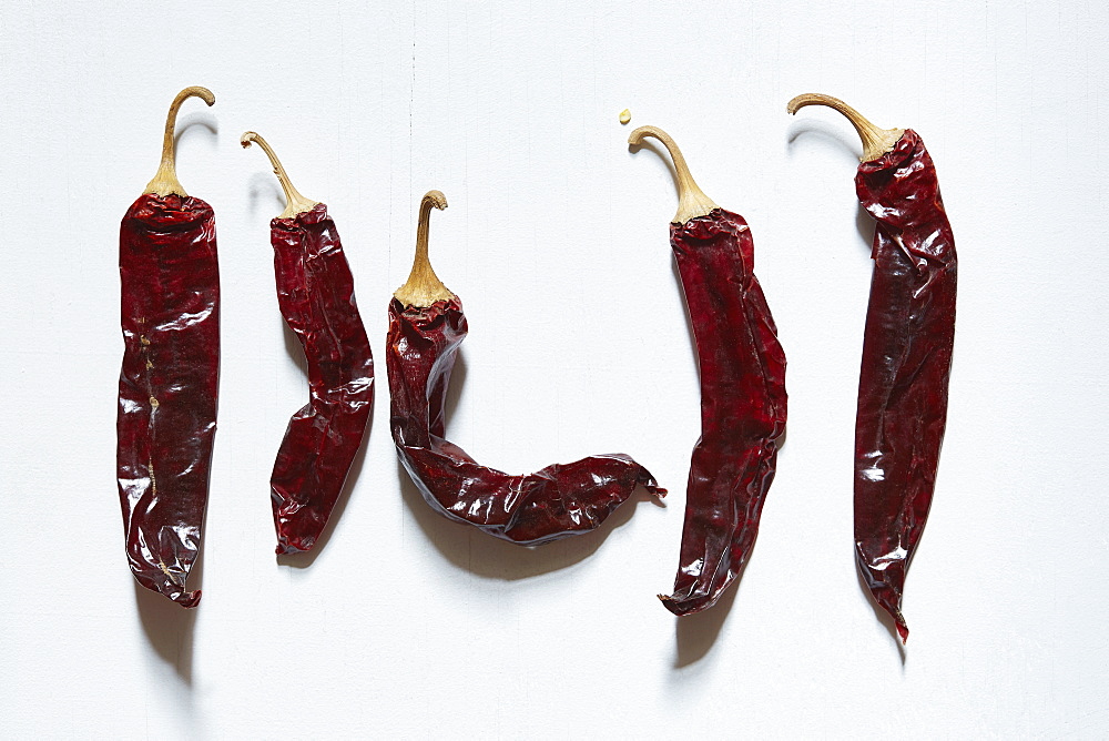 Dried chilli peppers on white background