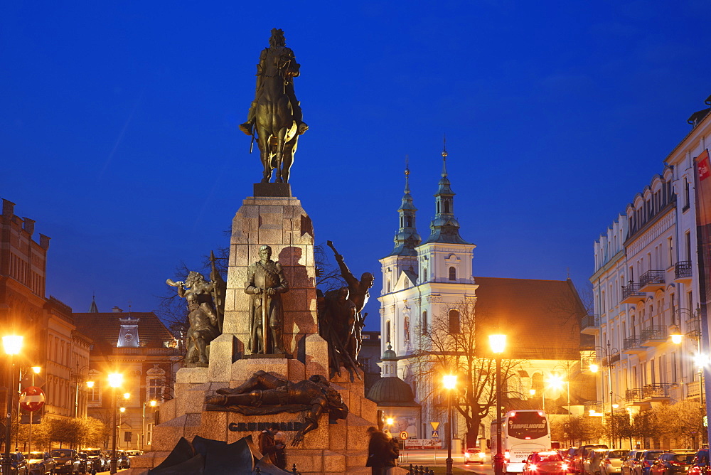 Poland, Lesser Poland, Krakow, Monument with statues on illuminated old town square