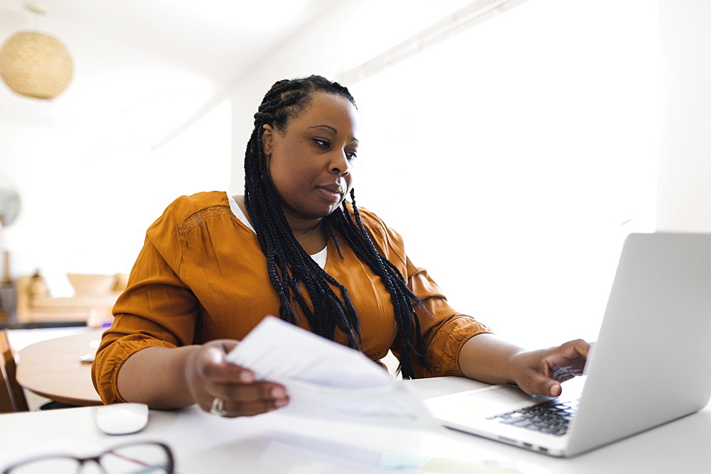 Woman working at desk in home office