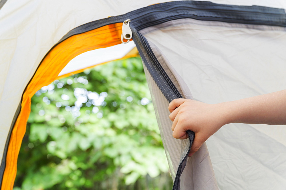 Boys (4-5) hand opening tent door