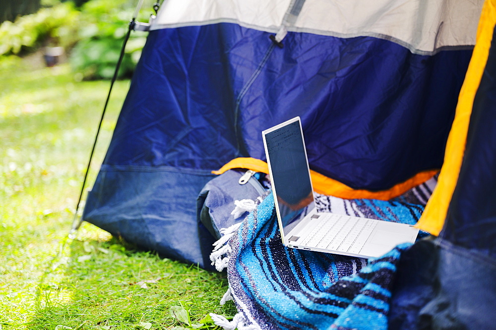 Tent and laptop in garden