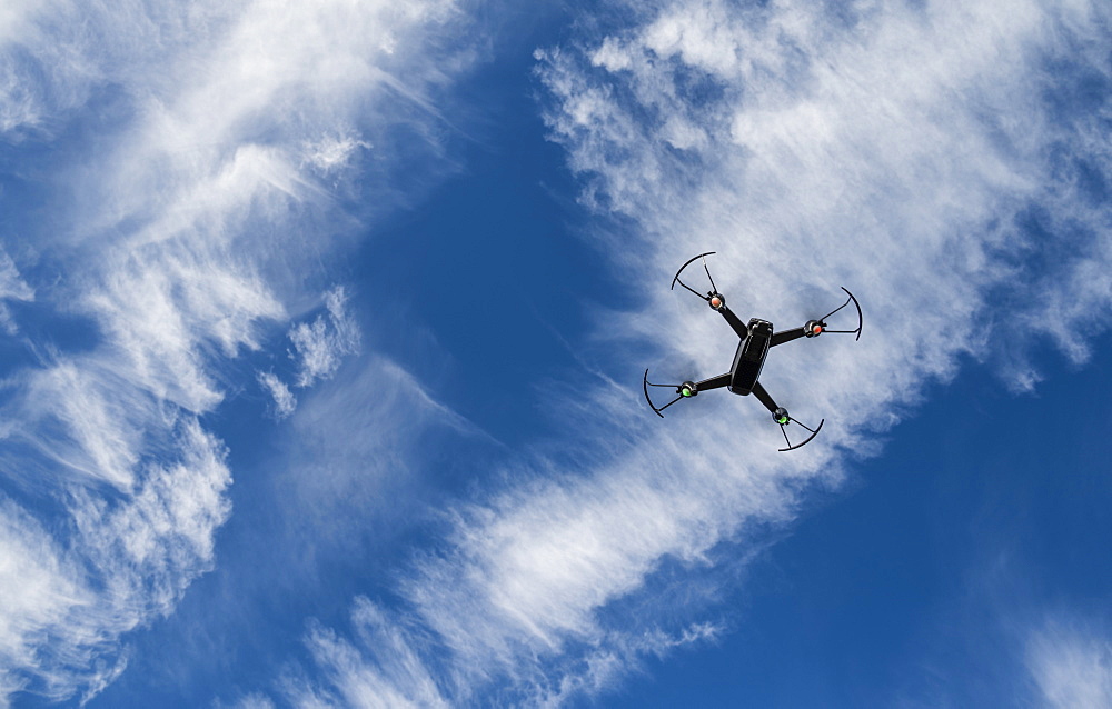 Low angle view of drone flying against sky