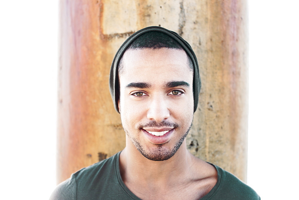 Smiling Hispanic man wearing cap